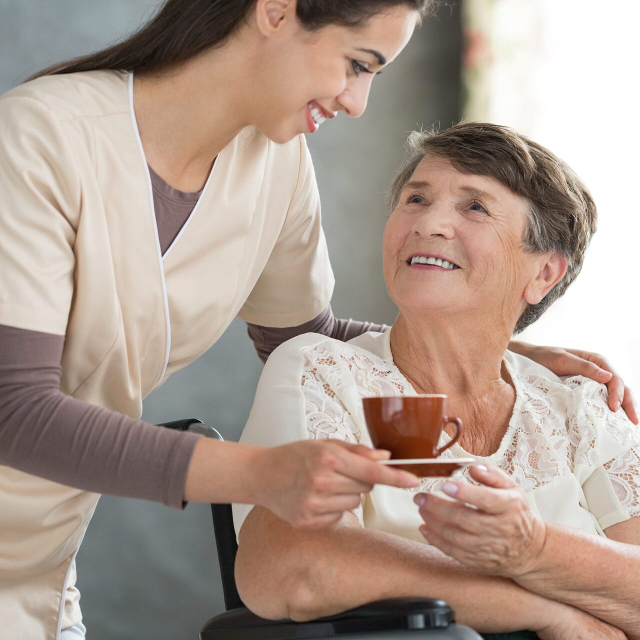 woman serving tea to another woman